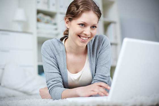 girl-smiling-working-on-laptop girl smiling working on laptop